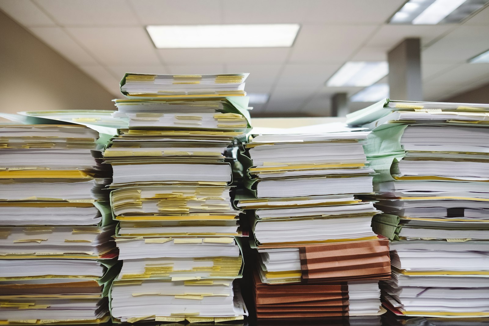 Stacks of business documents and file folders